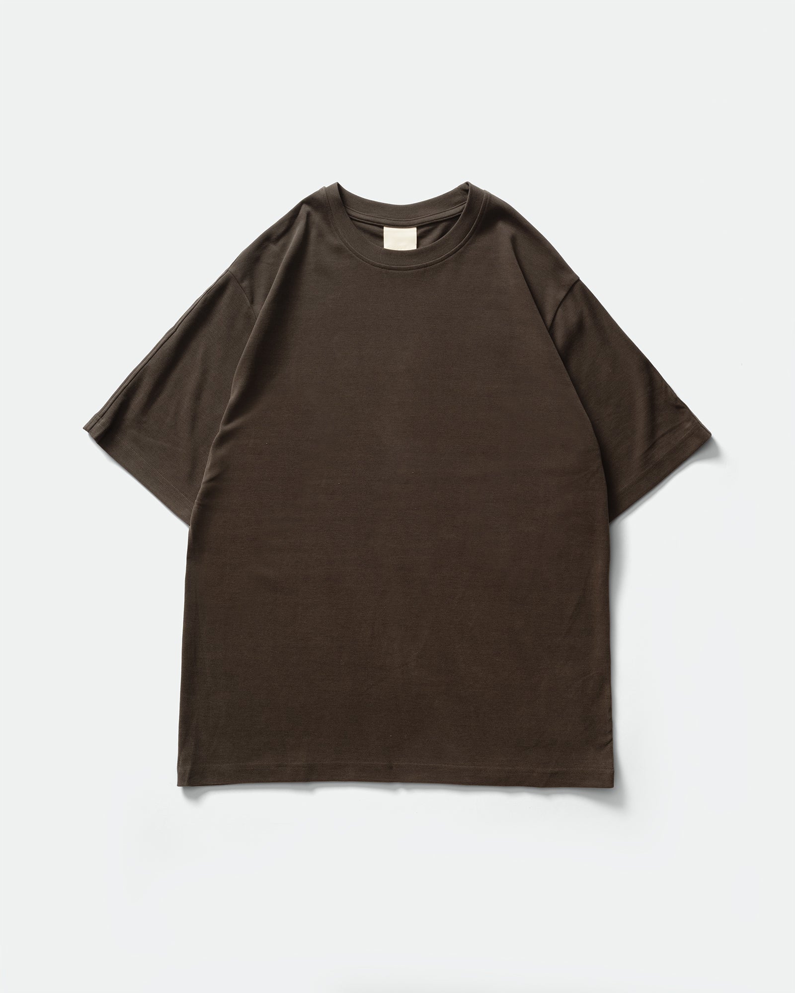 Pack shot of GRAYE Cupro Signature Tee in Herbal Grey with a short-sleeve crewneck on a grey background.