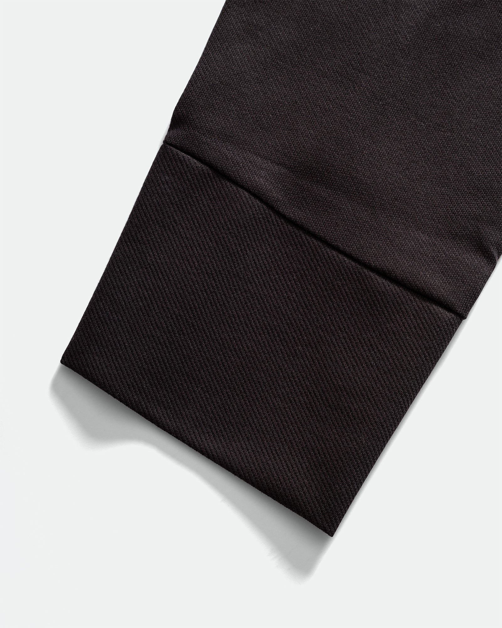 Close-up of IKIJI Navy Blouson Shirt Jacket cuffs on grey background.