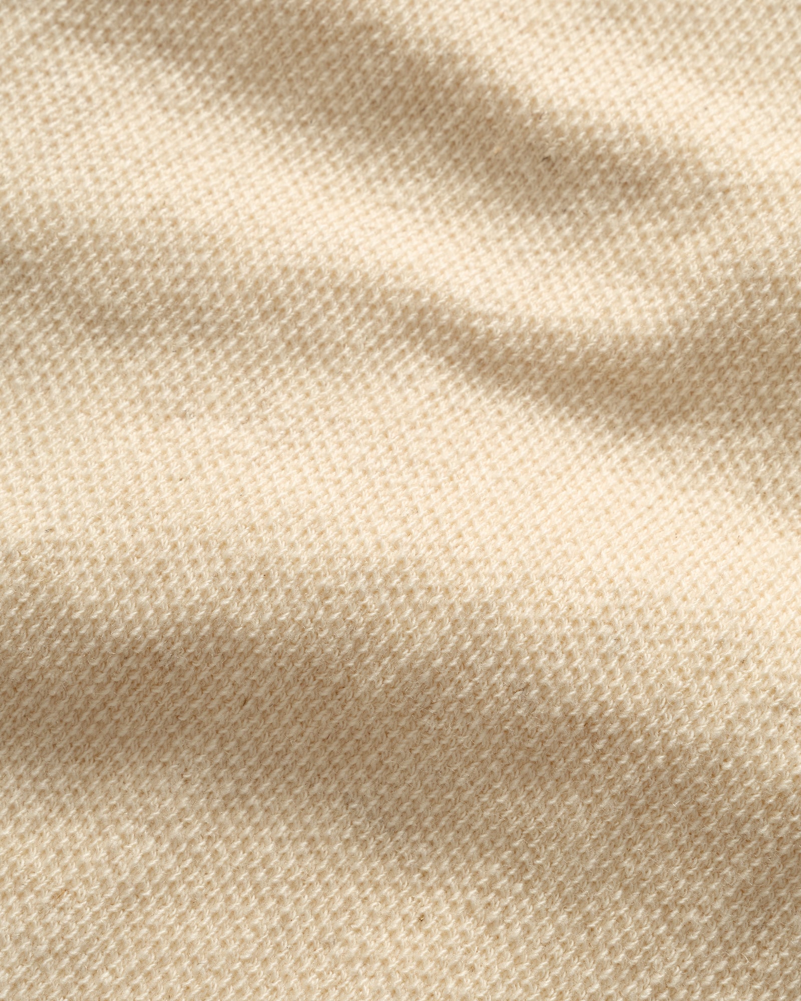 Close-up of IKIJI White Work Jacket fabric texture.