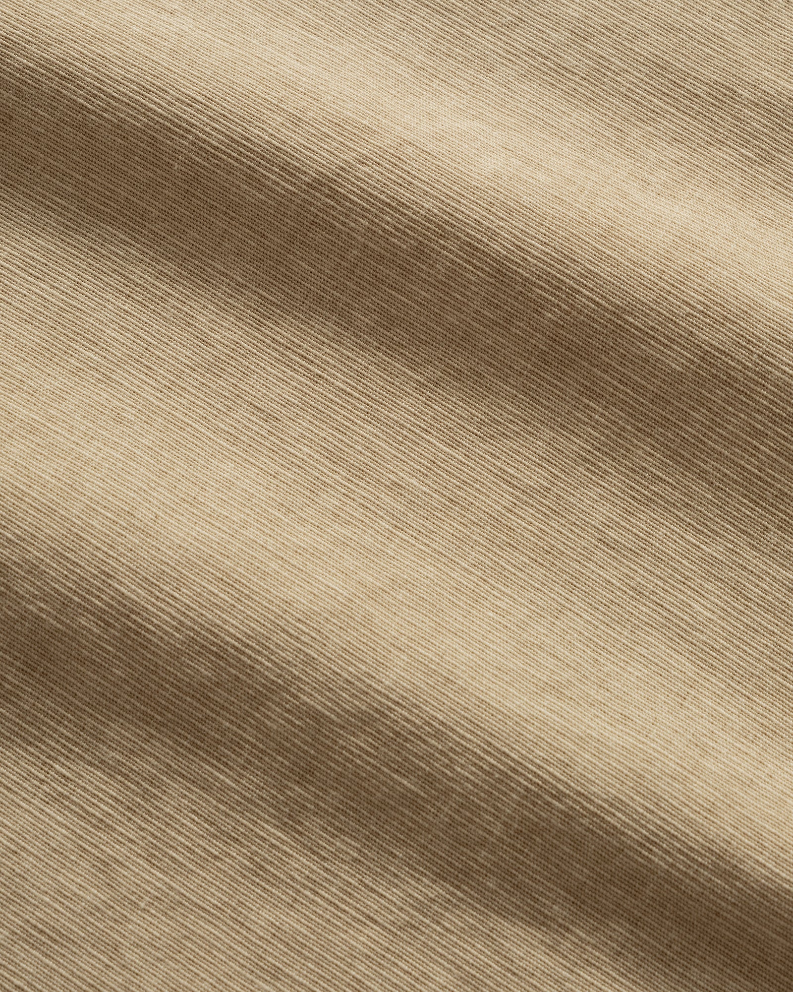 Gradient of Pigment Henleyneck Half Shirt shades on a beige textured material