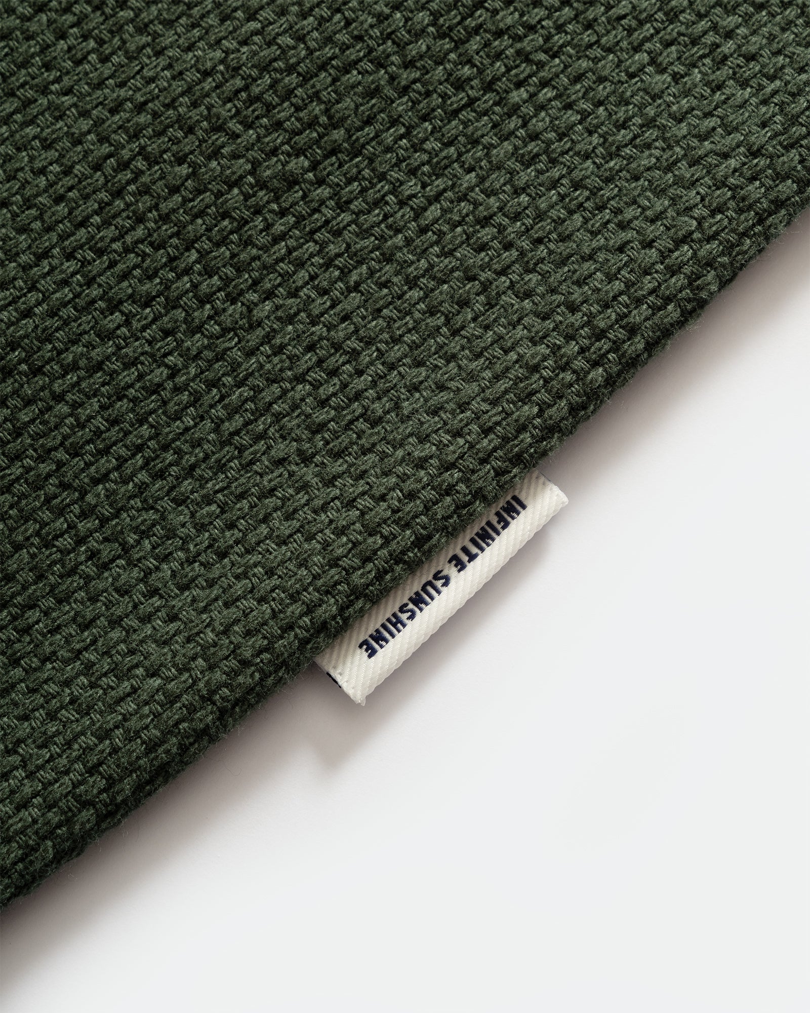 Close-up of Kappy Green Woven Cotton Vest with label and visable texture of fabric