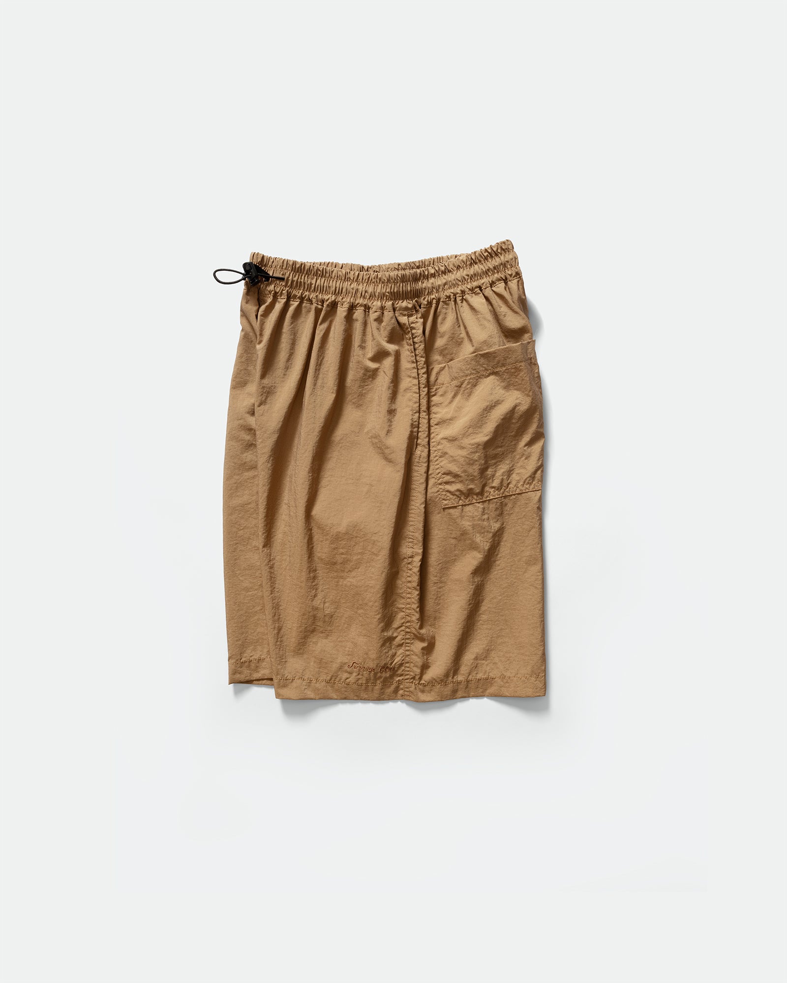 Side pack shot of Kappy brown nylon shorts with an elasticated drawstring waistband on a grey background 