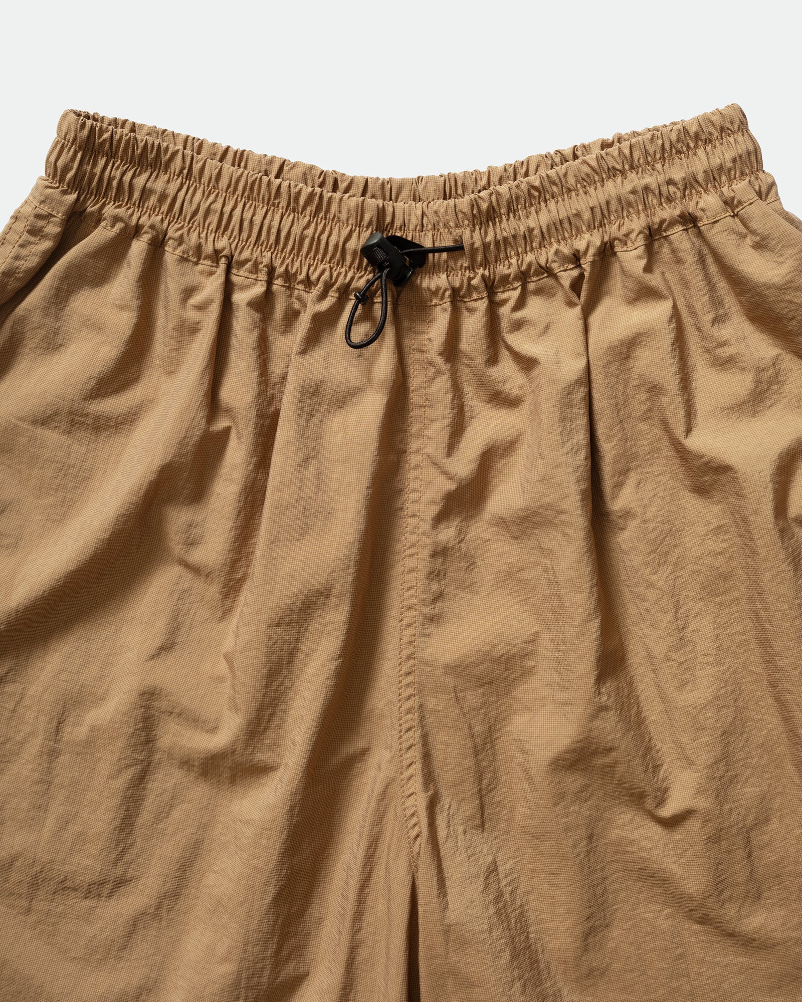 Close-up of brown Kappy nuylon shorts with a drawstring elasticated waistband on a light background