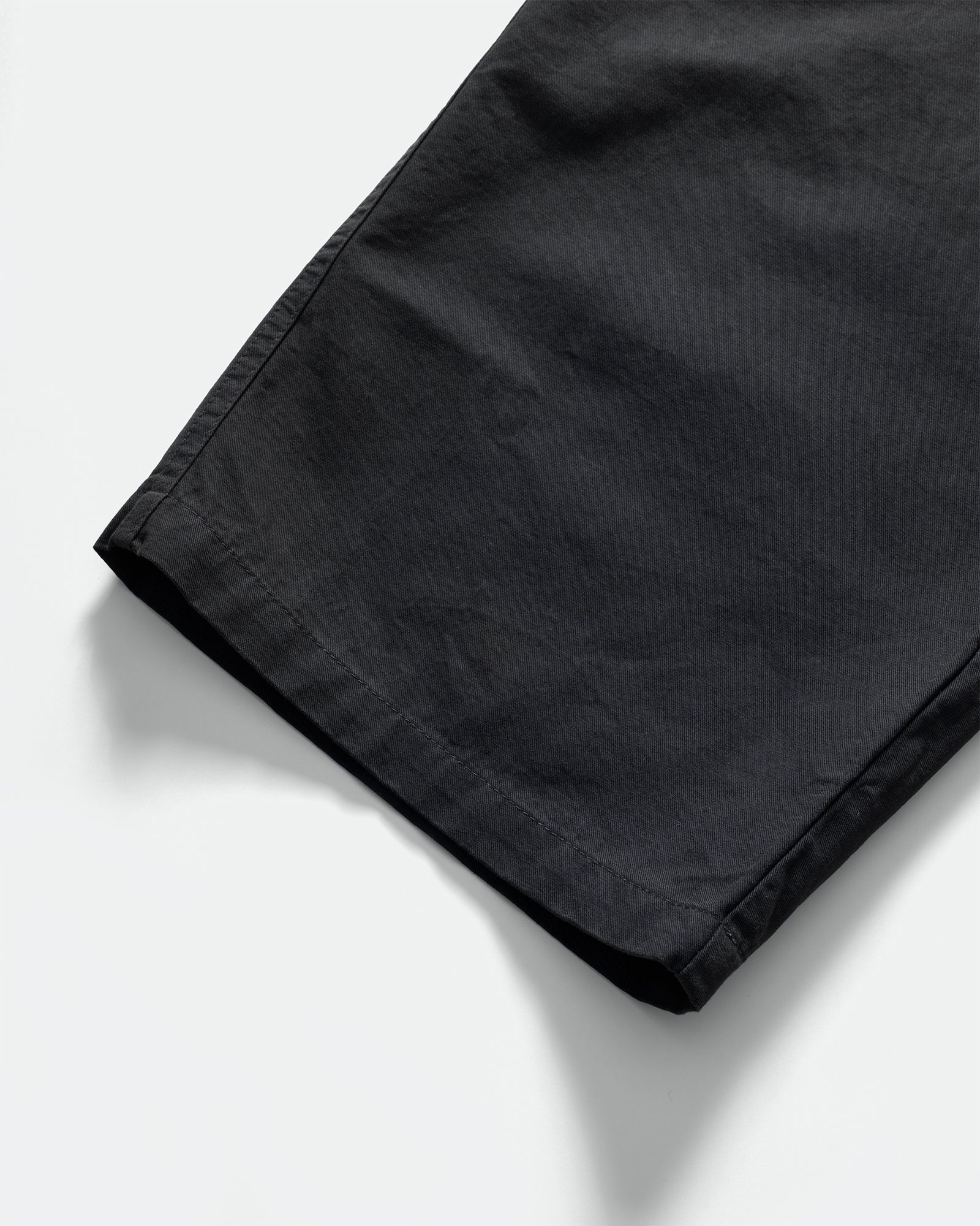 Close up of Kappy Navy Pintuck Chino Pants on a grey background