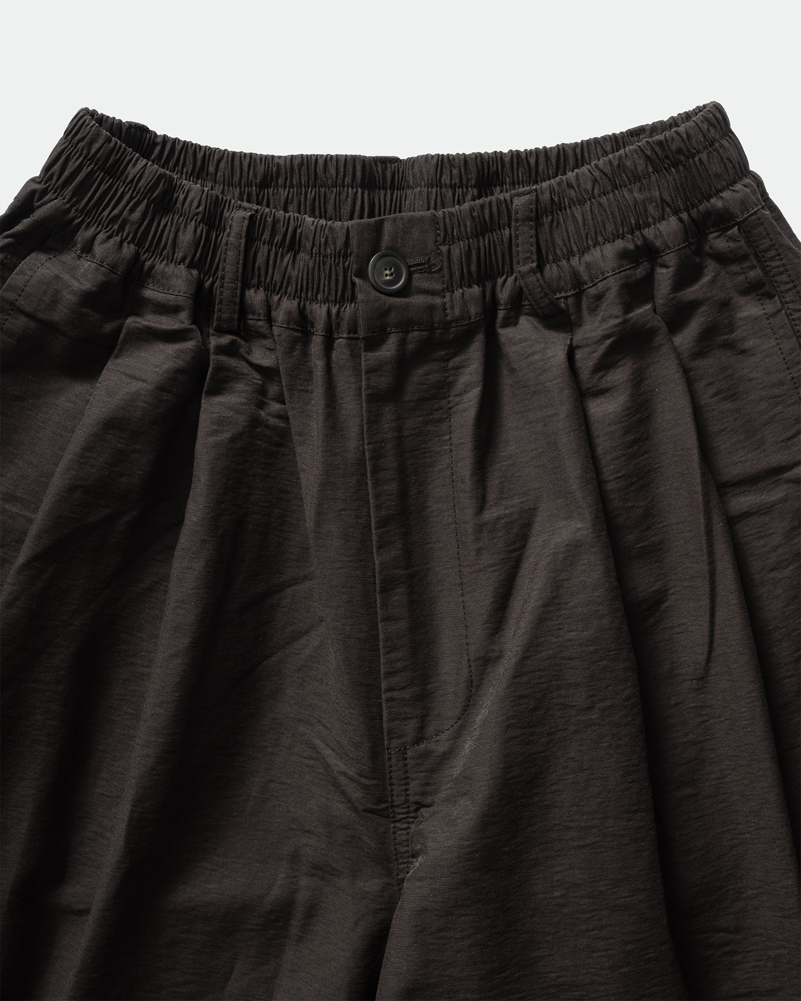 Close-up of black shorts with an elastic waistband, belt loops on a light gray background by South Korean brand, Kappy