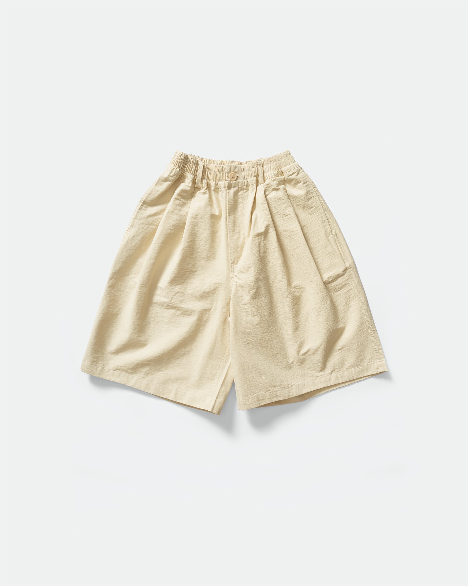 Pack shot of cream CN shorts with elasticated waistband, pockets and button hole by South Korean brand Kappy 
