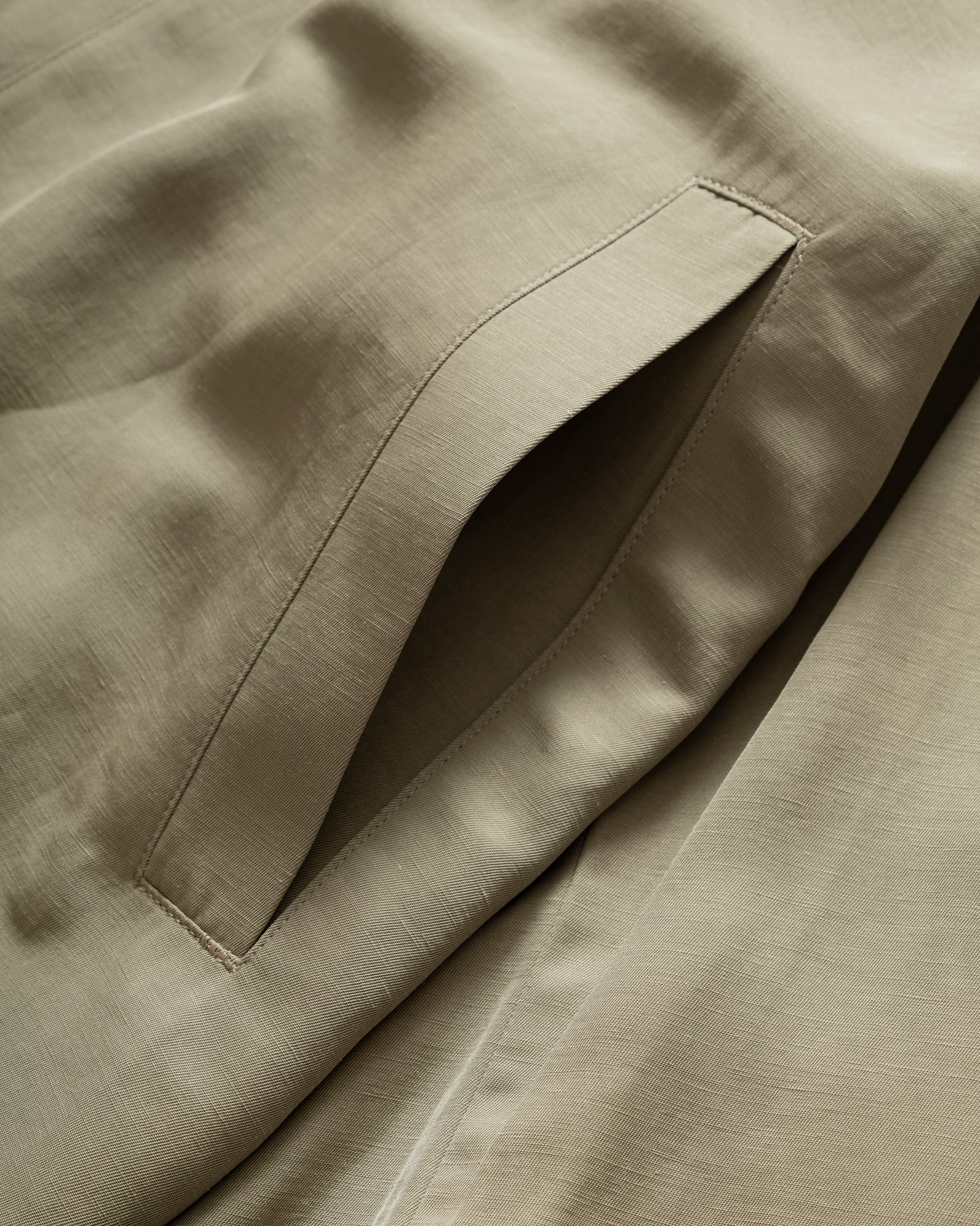 Close up of Still By Hand Sage Pigment Print Zip Blouson slip pocket and fabric detail.