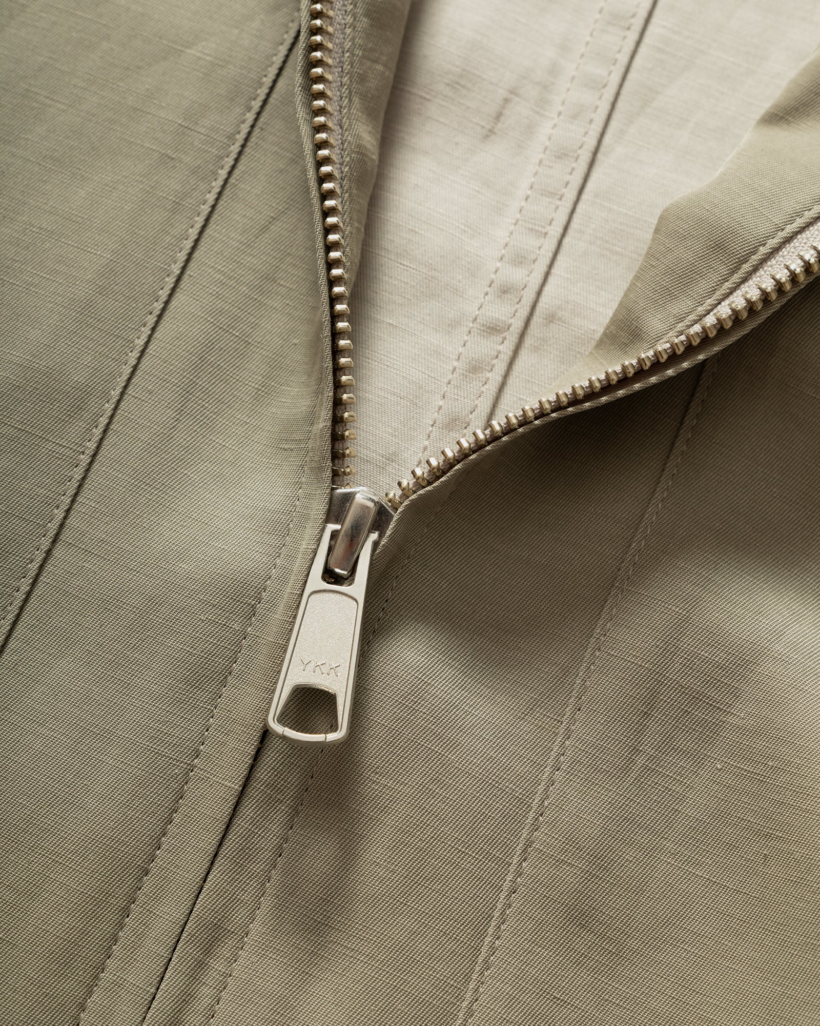 Close up of Still By Hand Sage Pigment Print Zip Blouson zip and fabric detail.