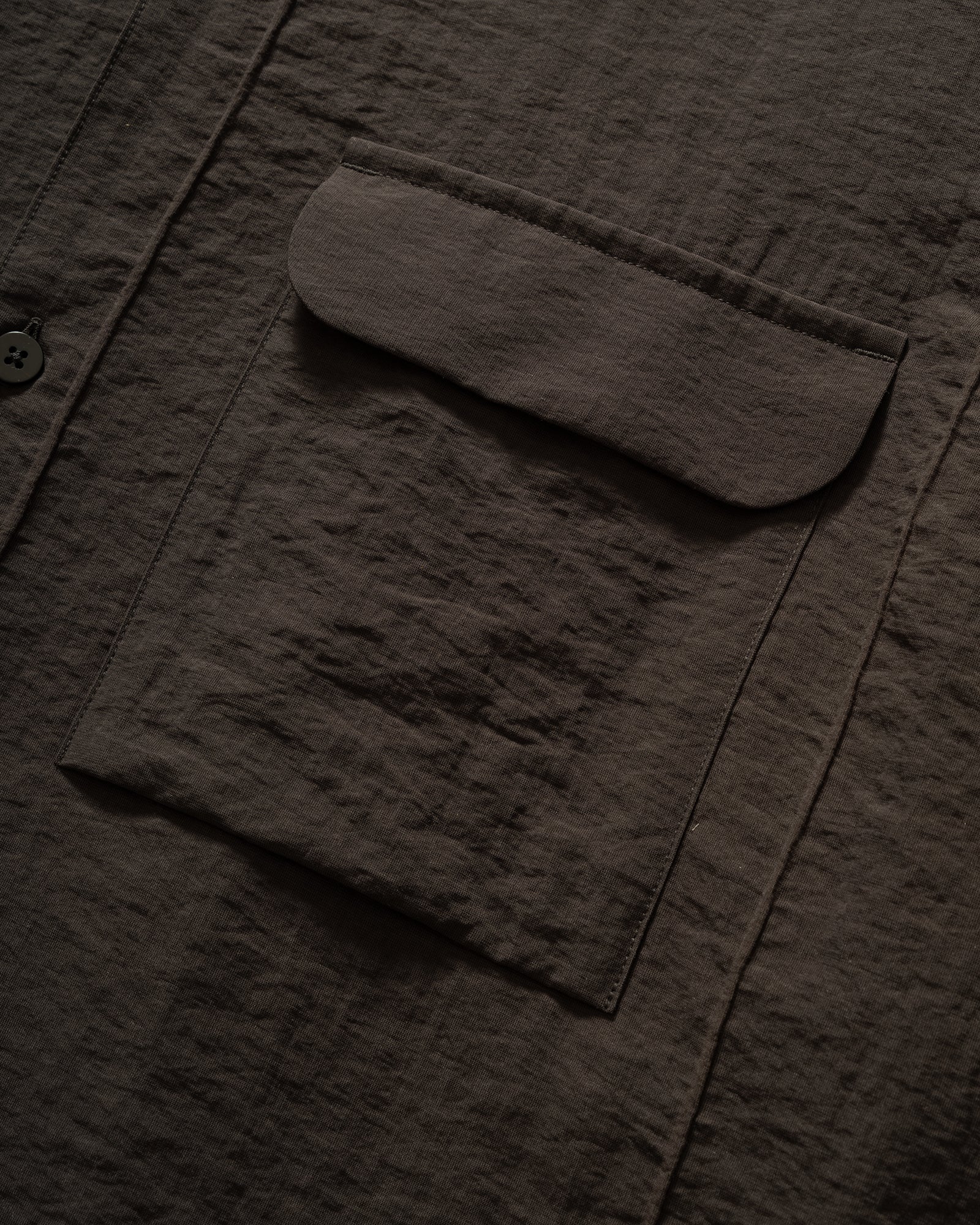 Close up of Still By Hand Pin Tuck Short Sleeve Shirt in Charcoal with chest pocket.