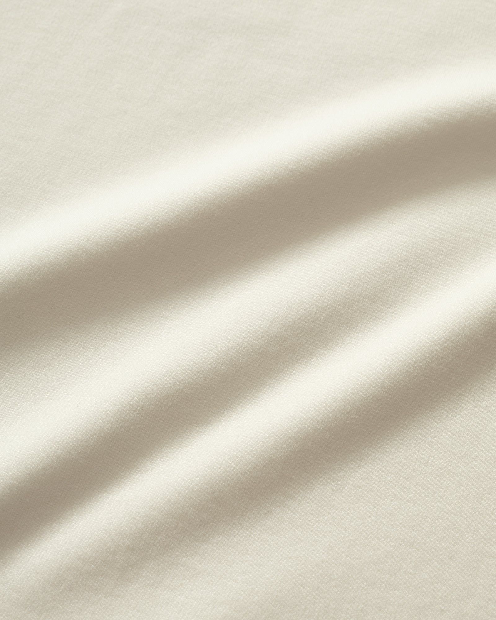 Close-up of off white fabric with soft folds