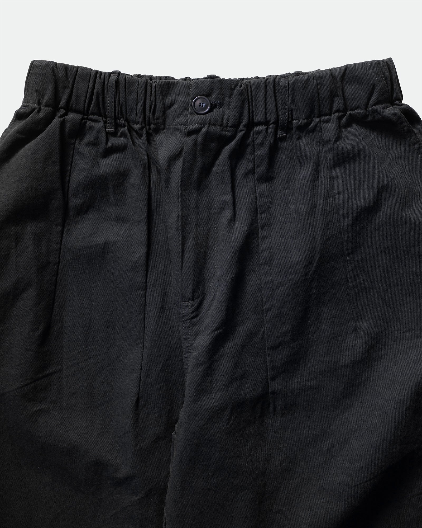 Close-up of navy Kappy Pintuck Wide Chino Pants with an elastic waistband on a light gray background.