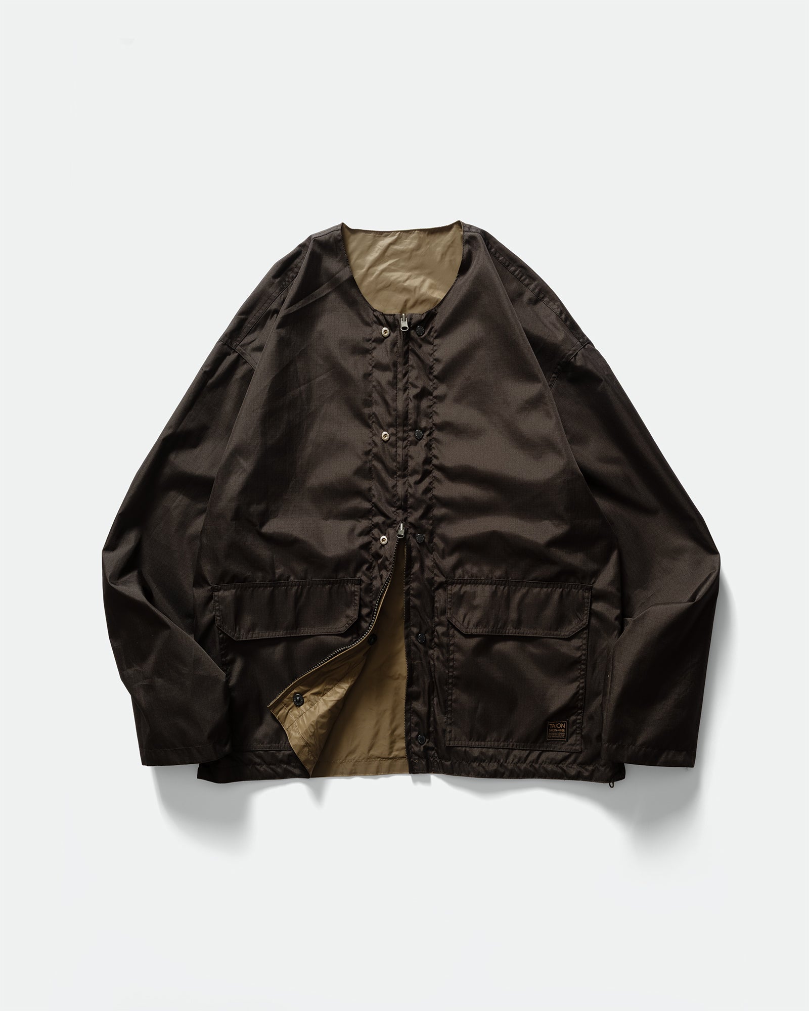 Pack shot of TAION Nylon Military Reversible Liner Jacket in Dark Olive and Brown with zip closure, patch pockets, crewneck on a grey background.